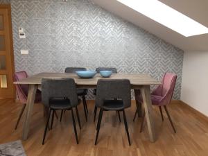a dining room table with chairs and blue bowls on it at Ático Jaca Ciudadela in Jaca