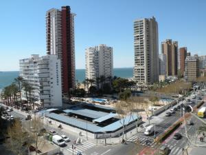 a city with tall buildings and a parking lot at Ducado - Fincas Arena in Benidorm