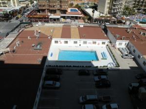 a swimming pool on the roof of a building at Ducado - Fincas Arena in Benidorm