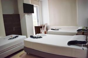 Llit o llits en una habitació de Hotel Sophia Real
