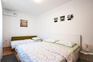 Posteľ alebo postele v izbe v ubytovaní Apartments Aria