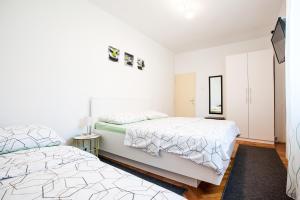 Posteľ alebo postele v izbe v ubytovaní Apartments Aria