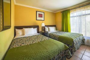 a hotel room with two beds and a window at Aparthotel Serena Dream in La Serena +49 photos