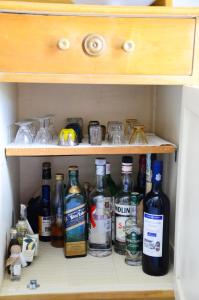 a cabinet filled with lots of bottles of alcohol at Hillside Kolona View Villa in Mérikhas