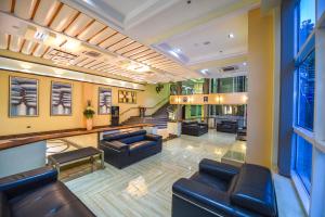 a lobby with couches and chairs in a building at BMK House Apartments in Kampala