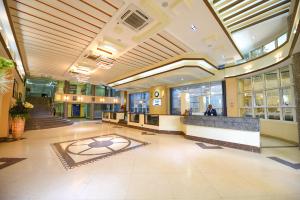 a lobby of a building with a large lobby at BMK House Apartments in Kampala