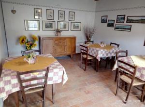 uma sala de jantar com duas mesas e um armário em agriturismo la scuderia em Galzignano