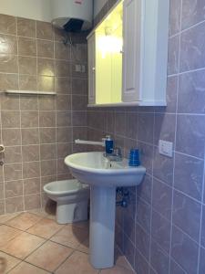 a bathroom with a sink and a toilet at Le Meridien in Olbia