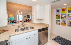 a kitchen with a sink and a dishwasher at Ocean Life Beach Condo - Only Steps to the Beach in Saint Augustine Beach