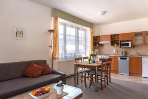 a living room with a couch and a table at Apartmany Aneta in Špindlerův Mlýn