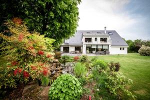 a large white house with a garden in front of it at Le champ du Renne in Le Mans