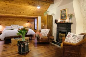 a bedroom with a bed and a fireplace at Kiln Wing, Old Corn Mill in Bushmills