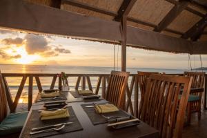 a table on the beach with a view of the ocean at Coral Strand Smart Choice in Beau Vallon