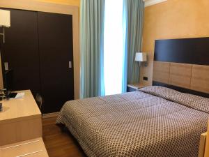 Posteľ alebo postele v izbe v ubytovaní Hotel Enrichetta