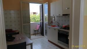 a kitchen with a sink and a stove top oven at Villetta Carati in Torre dell'Orso