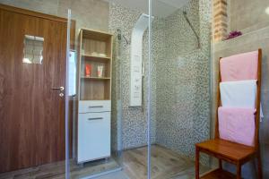 a bathroom with a glass shower with a wooden door at Bossa Studio Apartments in Split +47 photos