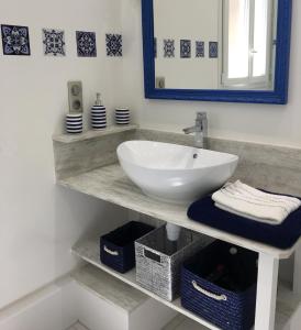 a bathroom with a white sink and a mirror at Les Citadines in Amboise
