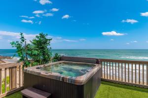 a hot tub on a balcony overlooking the ocean at Restoration Sands in Stuart