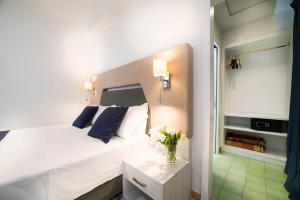 a hotel room with a white bed and white walls at Hotel Sole Splendid in Maiori