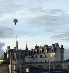 una mongolfiera che vola sopra un castello di Les Citadines a Amboise
