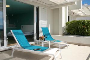 two blue and white chairs sitting on a patio at Apartments Villa Azzurra Bol in Bol