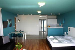 a living room with a bed and a kitchen at Apartments Villa Azzurra Bol in Bol