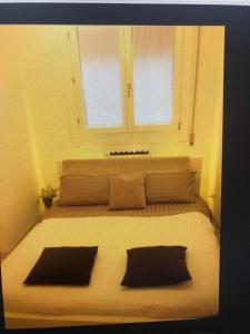 a bedroom with a large bed with two pillows at Jesolo pineta oasi verde ,spiaggia e mare in Lido di Jesolo