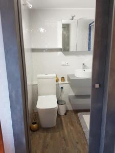 a white bathroom with a toilet and a sink at La cueva inès in Almería +38 photos