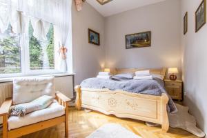 A bed or beds in a room at Apartamenty Krysin Zakopane