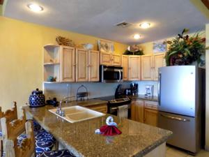 a kitchen with a sink and a refrigerator at Sonoran Sea 3BR Deluxe SSW 708 by Casago in Puerto Peñasco