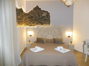 a bedroom with a large bed with two plates on it at Rio Groppo Guesthouse in Manarola