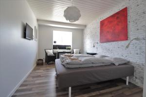 a bedroom with a bed and a brick wall at A-Bed in Esbjerg