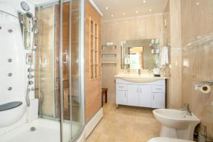 a bathroom with a shower and a sink and a toilet at Coral Strand Smart Choice in Beau Vallon