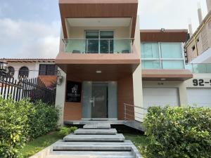 a house with stairs leading to the front door at Hotel Casa Nico in Barranquilla
