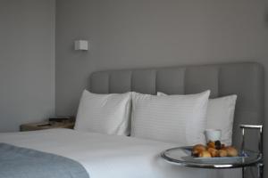 a tray of fruit sitting on top of a bed at ParkTower Suites in Beirut