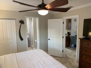 a room with a bed, a refrigerator, and a window at Twin Palms at Siesta in Siesta Key