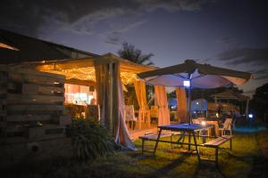 a table and an umbrella in a yard at night at Boulevard Inn Mt Meru in Arusha