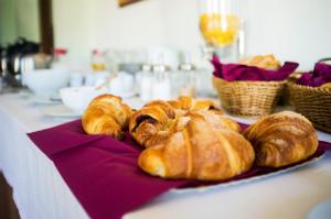 a plate of croissants and bread on a table at Agriturismo Murikè in Santa Marina