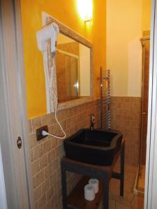 a bathroom with a sink and a mirror at Rio Groppo Guesthouse in Manarola