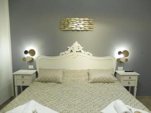 a bedroom with a large white bed with two night stands at Rio Groppo Guesthouse in Manarola