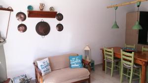 a living room with a couch and a table at Anemos Seaside House in Skiros