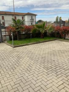 a brick driveway in front of a house at Relais fiera milano in Pero