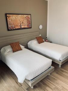 Ένα ή περισσότερα κρεβάτια σε δωμάτιο στο Relais fiera milano