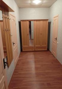 an empty hallway with wooden cabinets and a hard wood floor at Art Hotel in Izmail