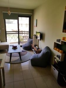 a living room with couches and a table at Ria Court 33 in Larnaca