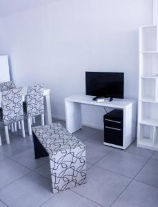 A television and/or entertainment centre at San Remo Apartments