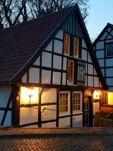 a black and white building with lights on it at Das Mühlchen in Ladbergen