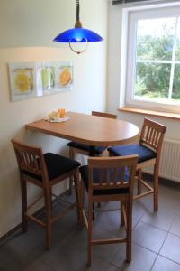 a dining room table and chairs with a blue light at Ferienwohnung Schmahl in Schleiden