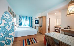 a hotel room with a bed and a bathroom at Universal's Endless Summer Resort - Surfside Inn and Suites in Orlando