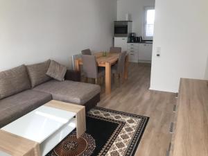 a living room with a couch and a table at Ferienwohnung An der alten Weed in Bad Windsheim